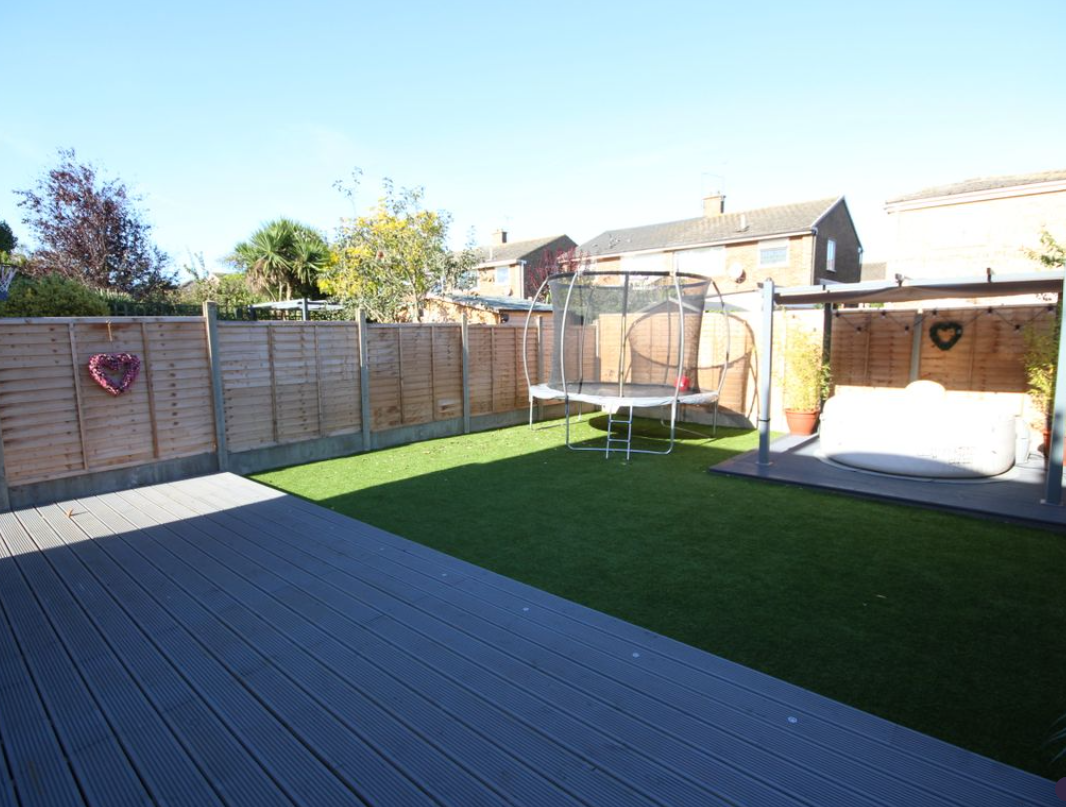 Refurbished garden with composite decking, artificial lawn and pergola seating area